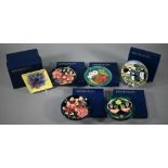 Five Moorcroft boxed circular pin-dishes, including puffins, Strawberry thief, cherries, honeysuckle