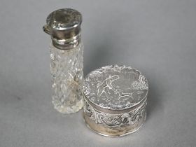 A Continental silver cylindrical snuff box, the hinged cover embossed with a huntsman with dog,