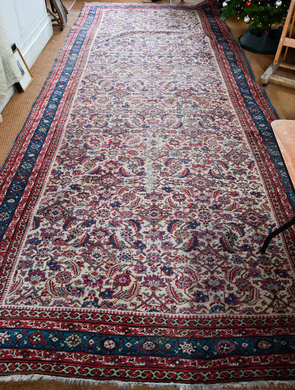 An antique Persian Bakhshayesh carpet, the geometric all-over repeat design on camel ground, 530