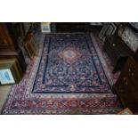 A fine Persian hand-made Tabriz carpet, the blue ground centred by a medallion, 368 cm x 265 cm