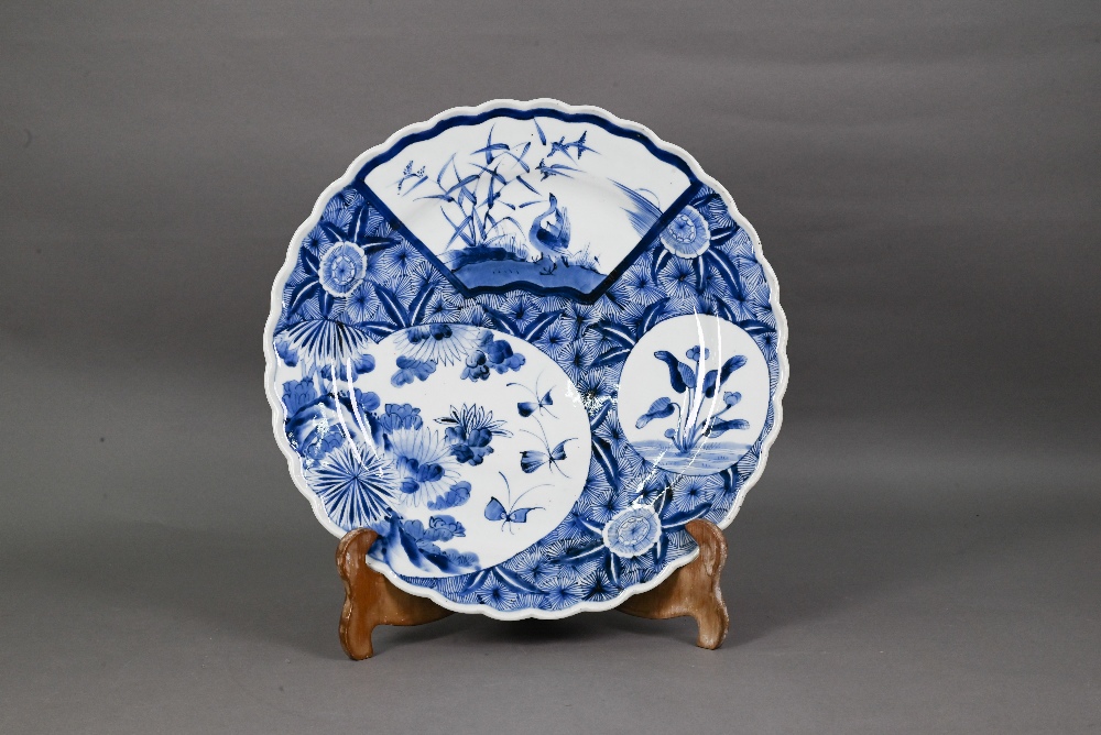 A 19th century Japanese blue and white floriform charger, painted with a goose and bamboo within a