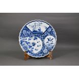 A 19th century Japanese blue and white floriform charger, painted with a goose and bamboo within a