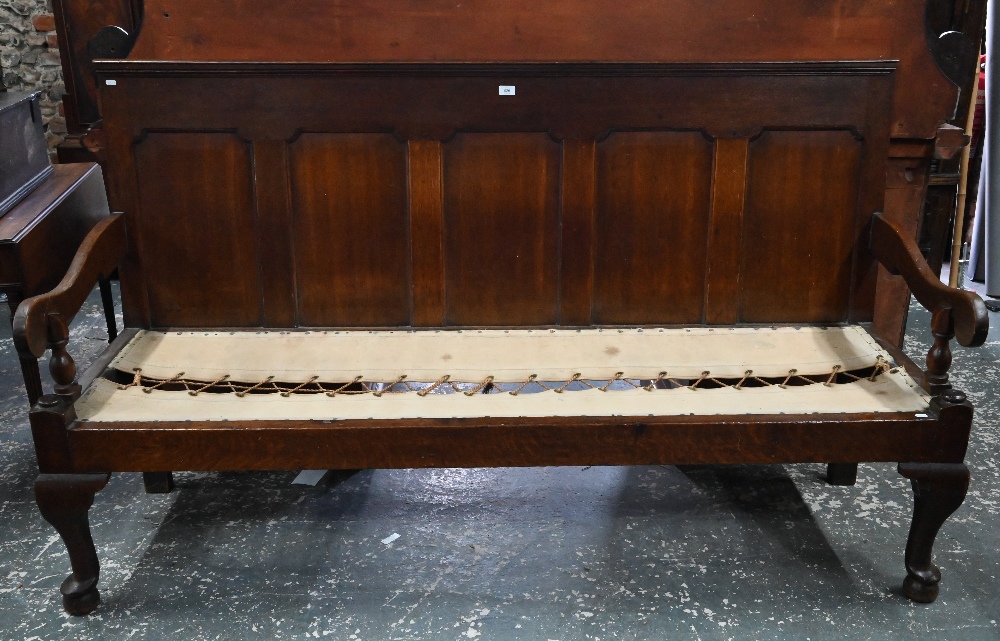An 18th century oak panel backed settle, with shaped arms over a rope and canvas seat (cushion - Image 2 of 6