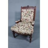 A late 19th/20th century walnut framed and moulded open armchair with autumn leaf and floral pattern