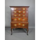An 18th century oak chest on stand comprising two short over four long graduated drawers, the