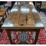 An antique French fruitwood extending draw leaf dining table, with frieze drawer to one end,