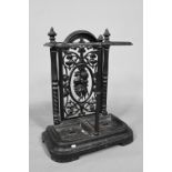 A late Victorian cast iron stick stand with twin drip pans, 50 cm w x 23 cm x 69 cm h