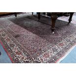 A Persian Bidjar red ground carpet, centred by a diamond floral lozenge, 335 cm x 247 cm