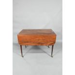 A Regency mahogany drop leaf Pembroke table, the top with round corners and reeded edge, raised over