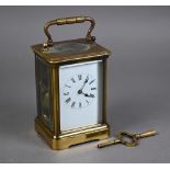 A traditional brass carriage clock, the 8-day twin drum movement with white enamelled dial (