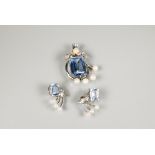 A South African brooch and earring suite, each set with rectangular baguette cut aquamarines with