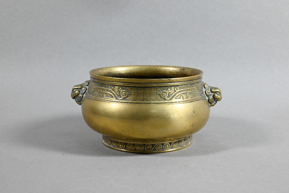 A 19th century Chinese bronze censer or incense burner of compressed globular form with cast