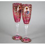 Pair of Venetian cranberry flash champagne flutes, printed with portraits of moustachioed potentate,
