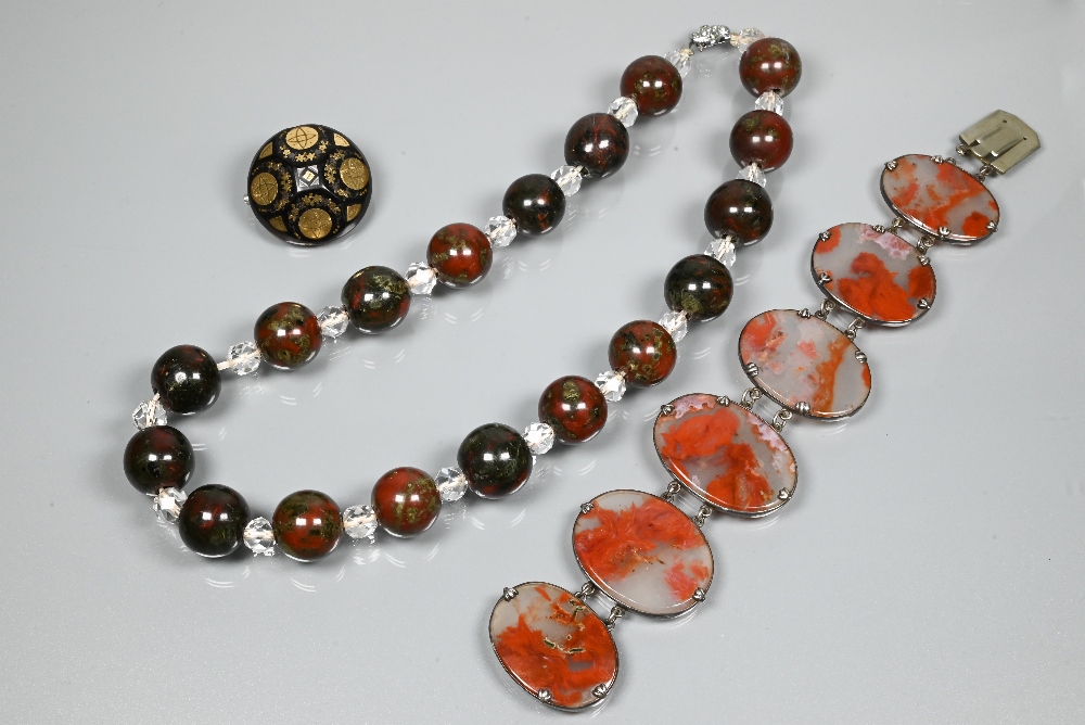 A moss agate bracelet formed of chain-linked oval discs, a Victorian piqué work brooch and a row