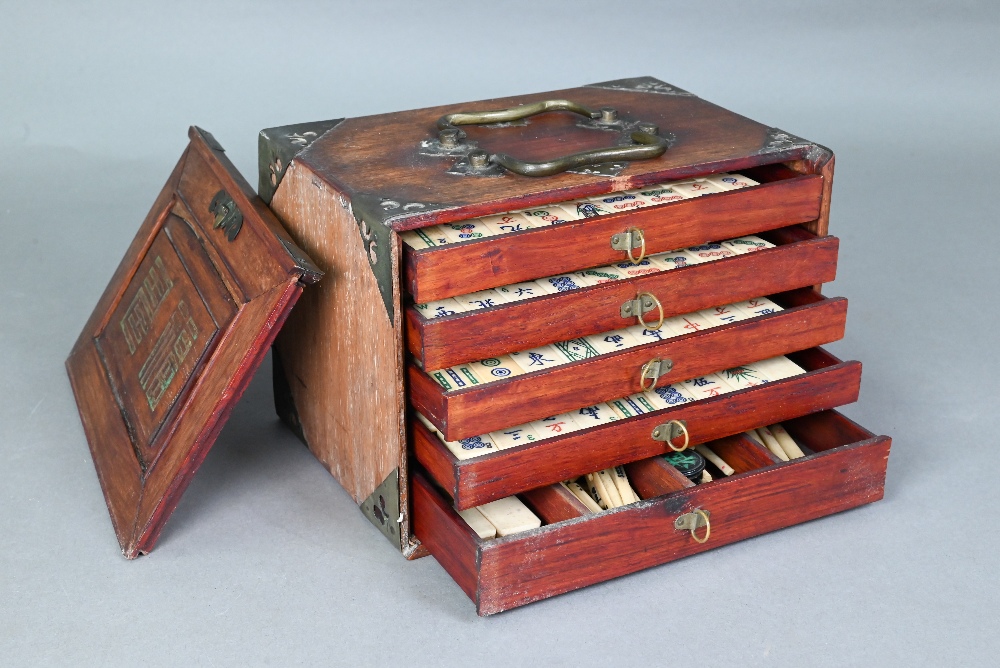 A Chinese Mah Jong set, the hardwood brass mounted case having two brass handles and sliding front