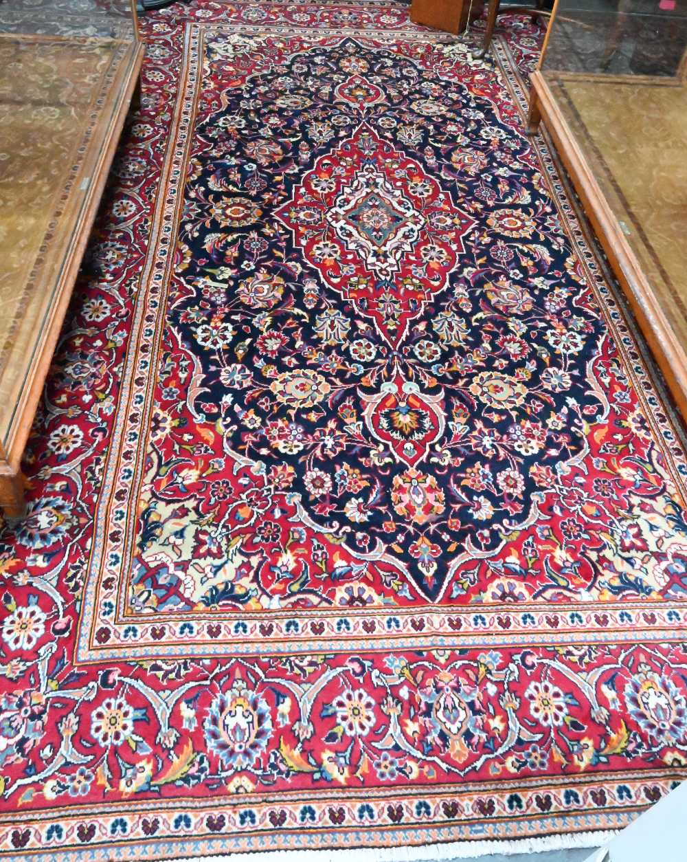 A contemporary central Persian Kashan carpet, the blue and red ground centred by a floral medallion,