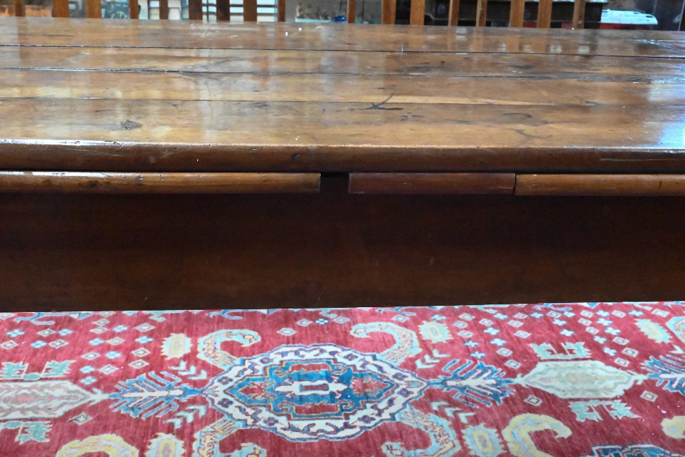 An antique French fruitwood extending draw leaf dining table, with frieze drawer to one end, - Image 5 of 15