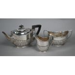 Late Victorian silver oval half-reeded tea pot with ebonised handle, William Hutton & Son, London