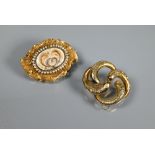 Two Victorian brooches - one with yellow metal shaped mount enclosing seed pearl and hairwork