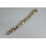 A 9ct yellow gold bracelet formed of elongated open square-edged oval links with curb links between,