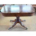 A Victorian ebony-strung mahogany card table, the fold-over top revealing a storage well, raised