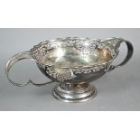 Silver bowl with Art Nouveau-style piercing and twin scroll handles, on raised moulded foot,