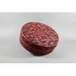 A large Chinese cinnabar lacquer circular box and cover, profusely carved with arrangements of bats,