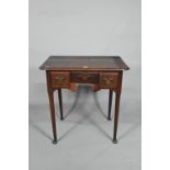 An 18th century oak three drawer low boy side table, raised on slender turned tapering legs to pad