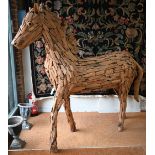 A large driftwood formed sculpture of a horse