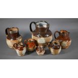 Matched set of eight Royal Doulton stoneware jugs with silver rims, 19-4.5 cm, one commemorating