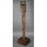 An Oceanic carved wood tribal pillar or sceptre, the stylised birds' heads and scroll decoration