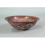 A Chinese chocolate brown glazed bowl, the interior decorated in low relief with two phoenix and