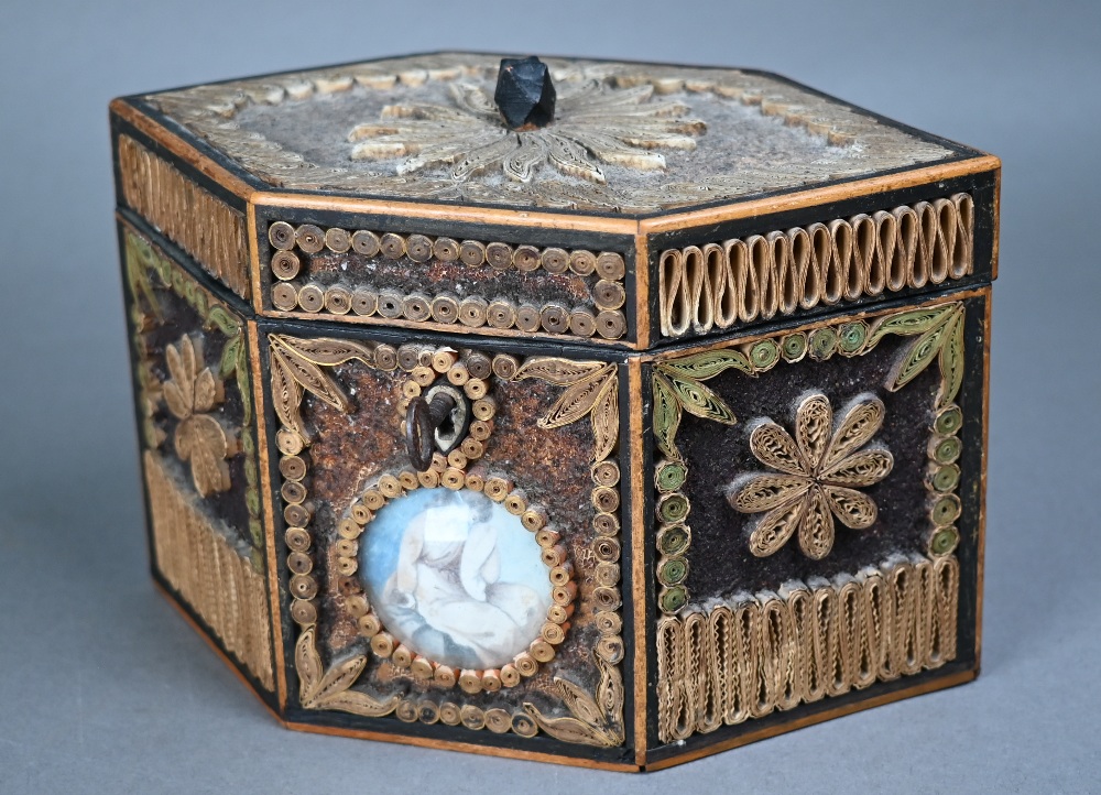 A George III tea caddy decorated with gilded rolled paper and crystal shards, and inset with two