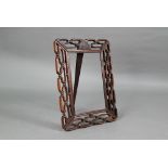 A 20th century Chinese pierced hardwood frame with carved 'shou' symbol and strut stand, 30 cm