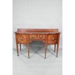A George III boxwood inlaid mahogany Sheraton design sideboard, of bow-breakfront form with a raised
