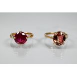 Two single stone rings - possibly red and pink topaz set, one 9ct yellow gold, the other unmarked,
