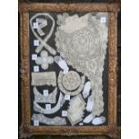 A collection of various antique lace examples to include collars, cuffs, edgings etc, framed, 148