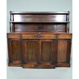 An early Victorian rosewood breakfront chiffonier, the two tier graduated open shelf over three