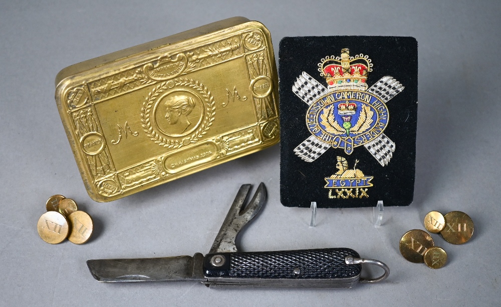 A WWI Queen Mary Christmas tin to/w a Cameron Highlanders officers swagger stick, cap badge and