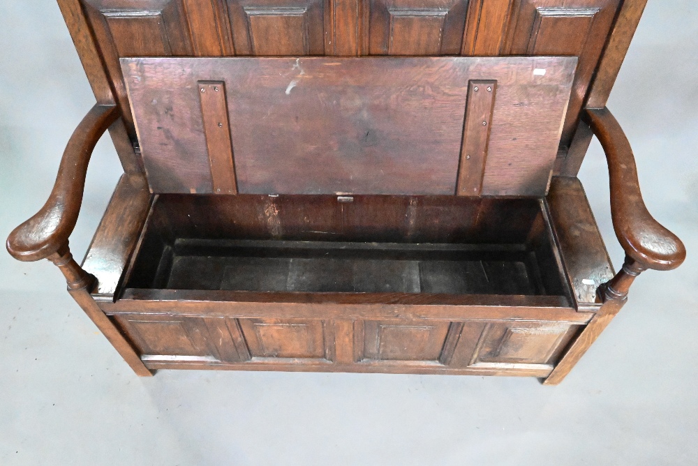 An antique oak box settle, the panelled back with floral carved rosette's over shaped arms and an - Image 3 of 6