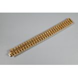 A yellow gold wide bracelet formed of fancy baton links, concealed clasp, stamped 750, approx 29g