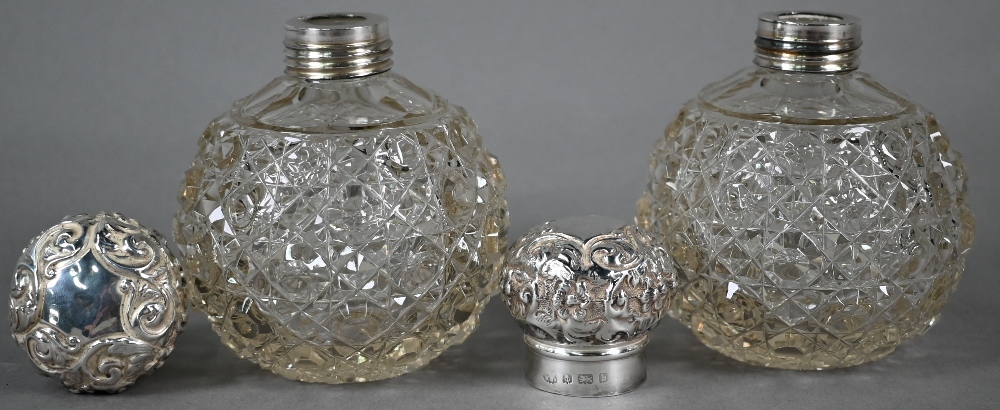 Pair of Edwardian cut glass globular scent bottles with embossed silver screw bun covers, Birmingham - Image 2 of 3