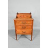 An inlaid mahogany chest with two drawer stage-back over three long drawers, raised on square