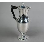 Unmarked white metal baluster hot water jug with hinged cover and stemmed foot, with beaded rims;
