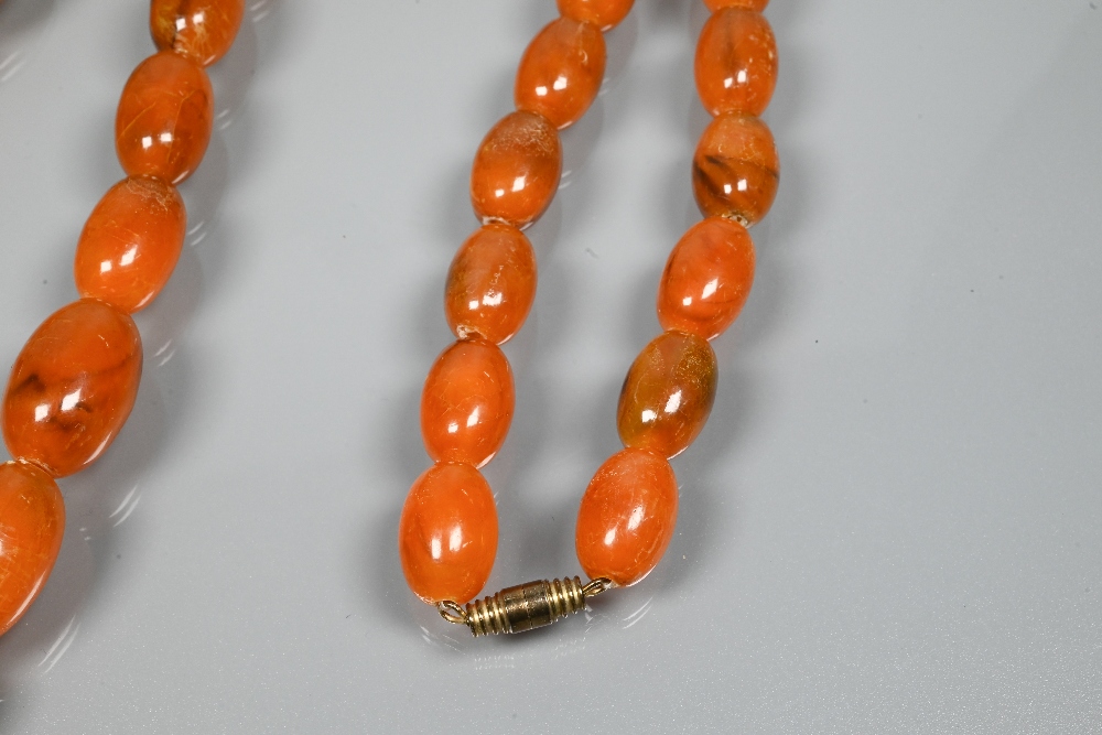 A graduated row of amber beads, 3 x 2 cm the largest bead, 1 x 0.7 cm the smallest, approx 64g all - Image 3 of 4