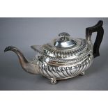 George silver teapot in the Regency style, of half-reeded oblong form with foliate finial, gadrooned