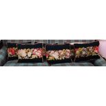 Six black ground needlepoint floral design cushions (6)