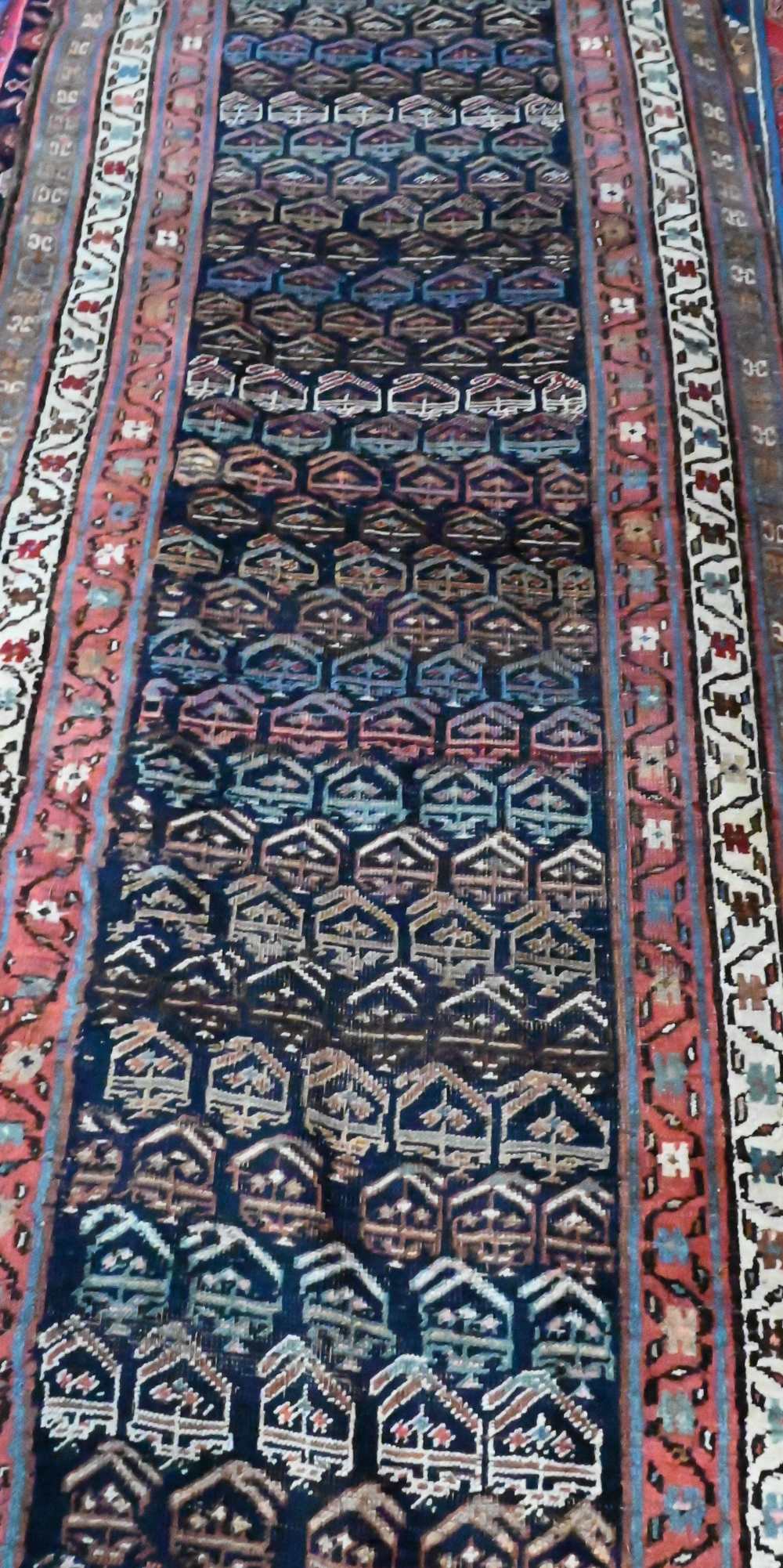 An antique Persian Kurd runner, the ink blue ground with repeating rows of stylised boteh, 417 cm  x - Image 2 of 3