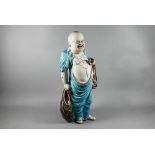 A 20th century Chinese part-glazed bisque porcelain figure of Budai Hehang (Laughing Buddha)