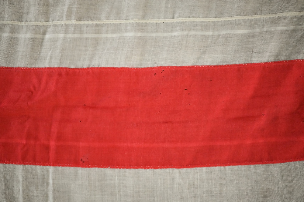 A WWII period Royal Navy ensign, of stitched panels with 'union jack' to top corner, stencilled 'C - Image 5 of 5